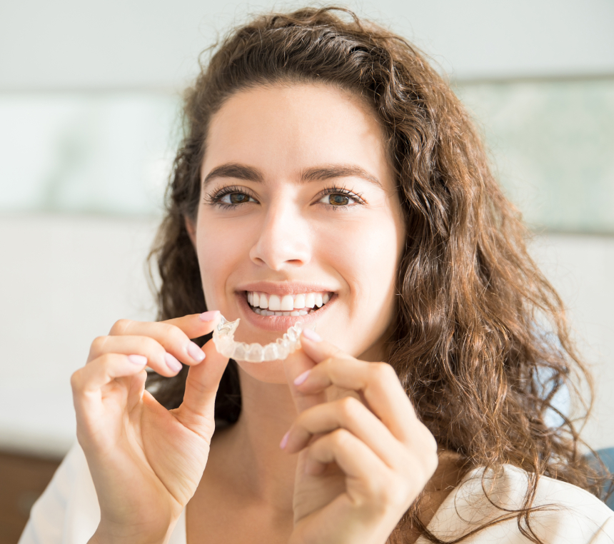 A patient smiling with her clear aligner at Central Dental Group