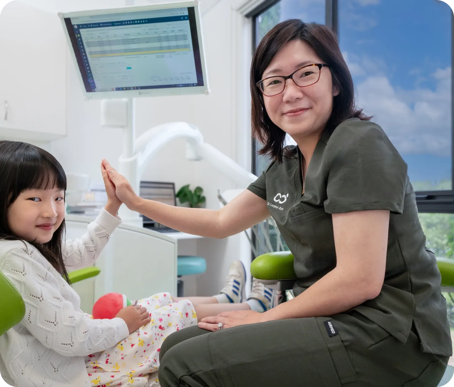A young patient sharing a moment with one of our dentists